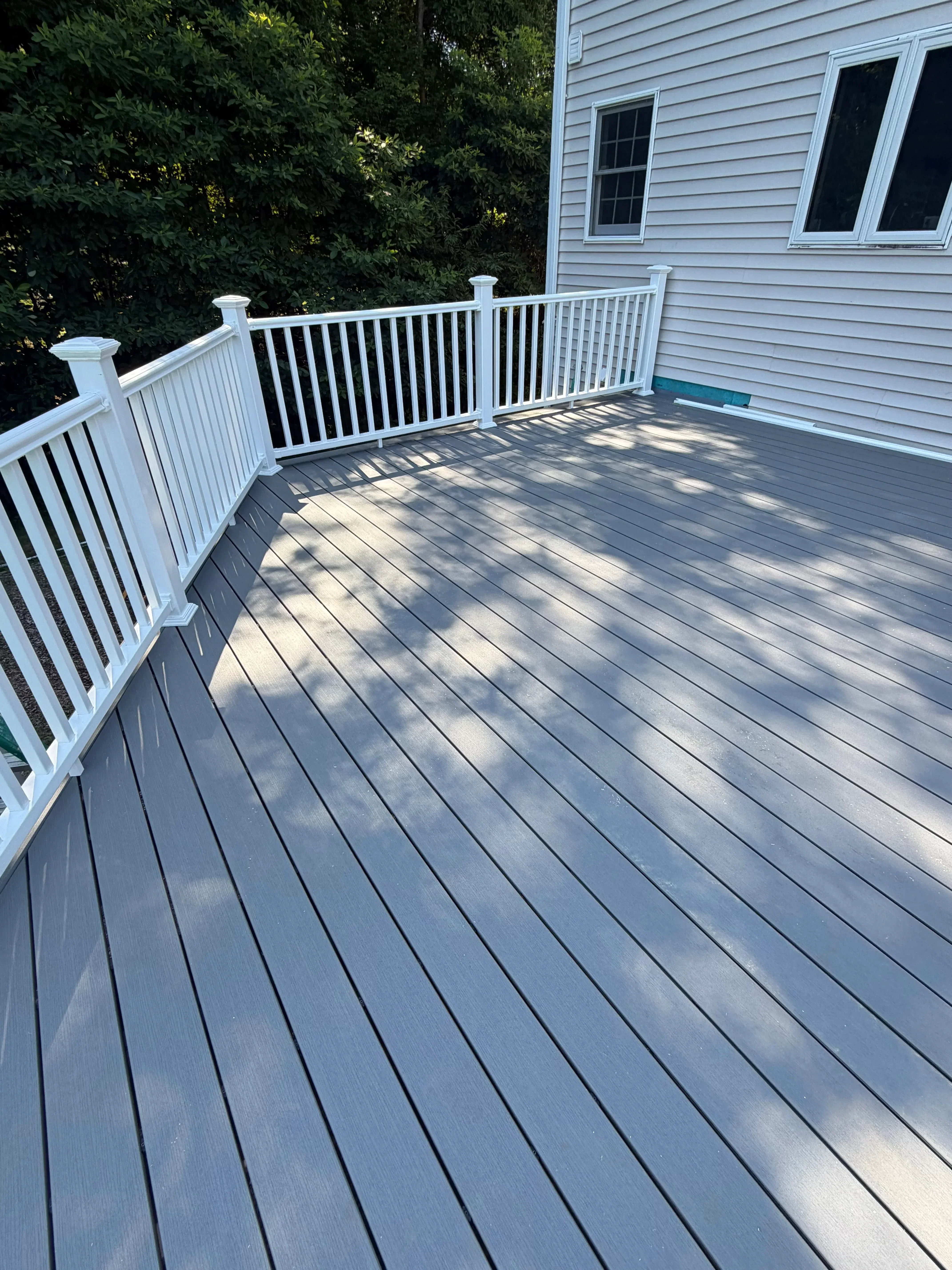 Standing seam metal roof with white aluminum stairs and landing on commercial building