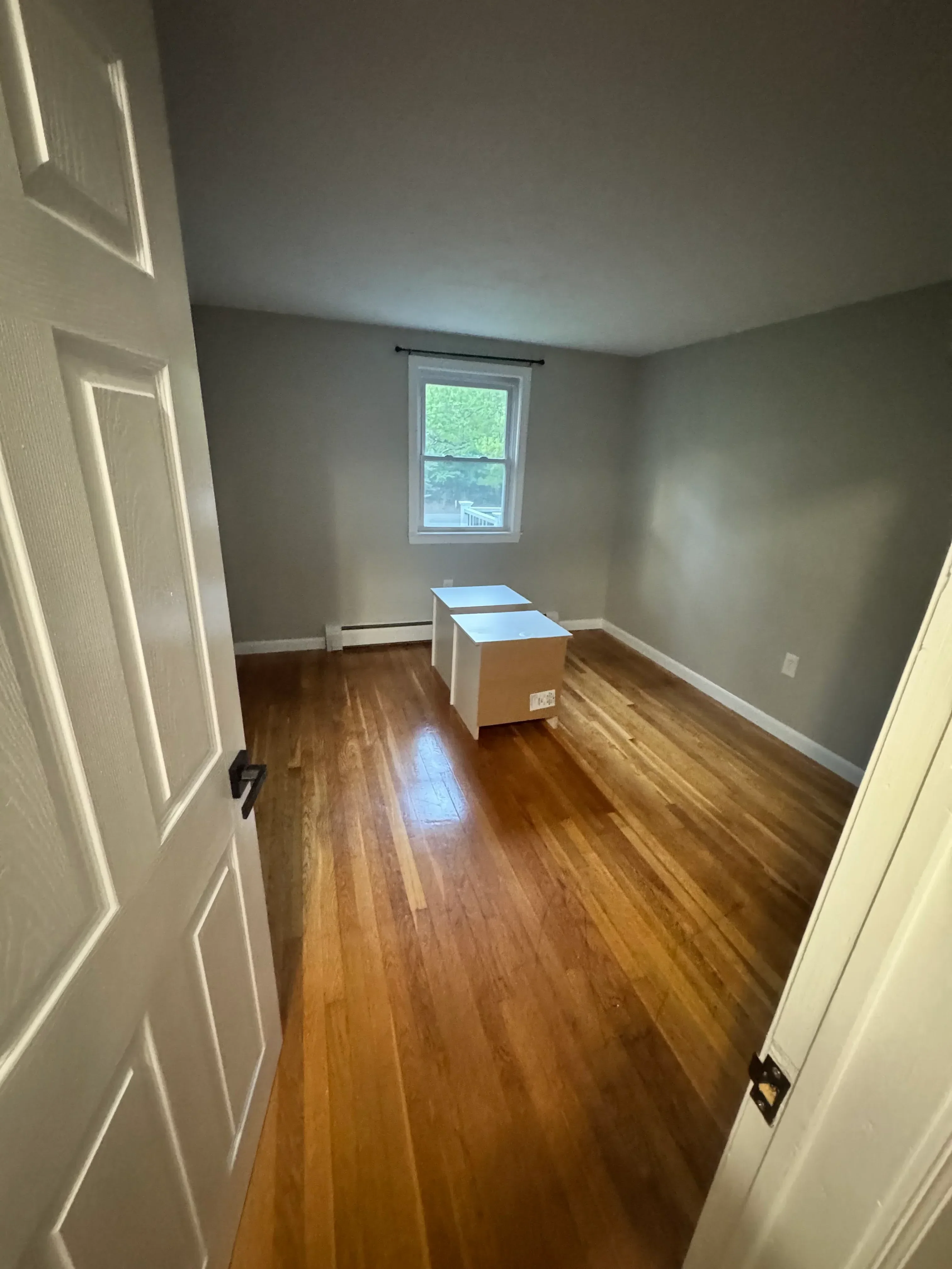 Horizontal wood shiplap accent wall with white trim, recessed lighting, and built-in shelving in bedroom