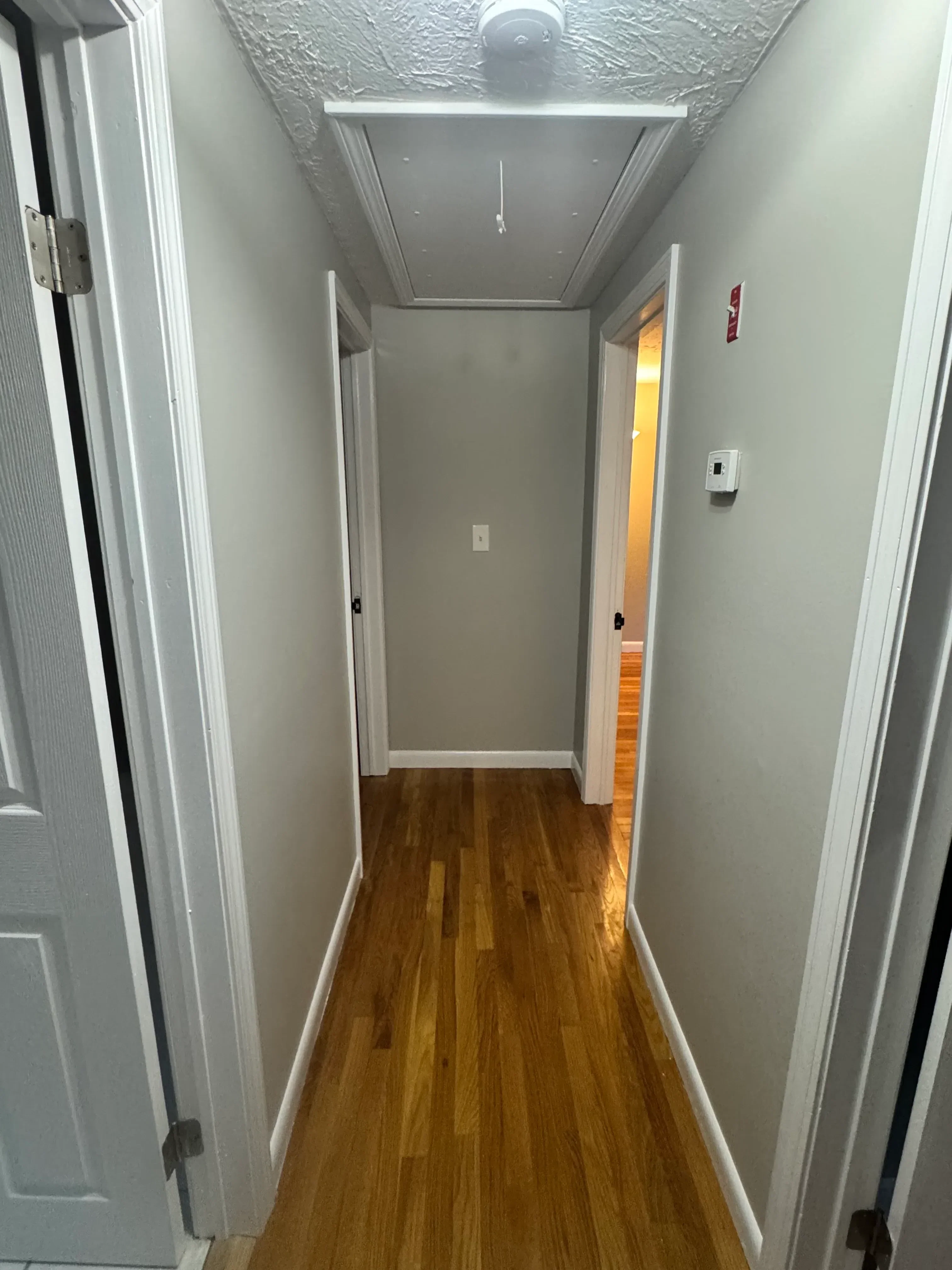 Garage interior with wood accent wall, white trim, recessed lighting, and built-in storage shelving