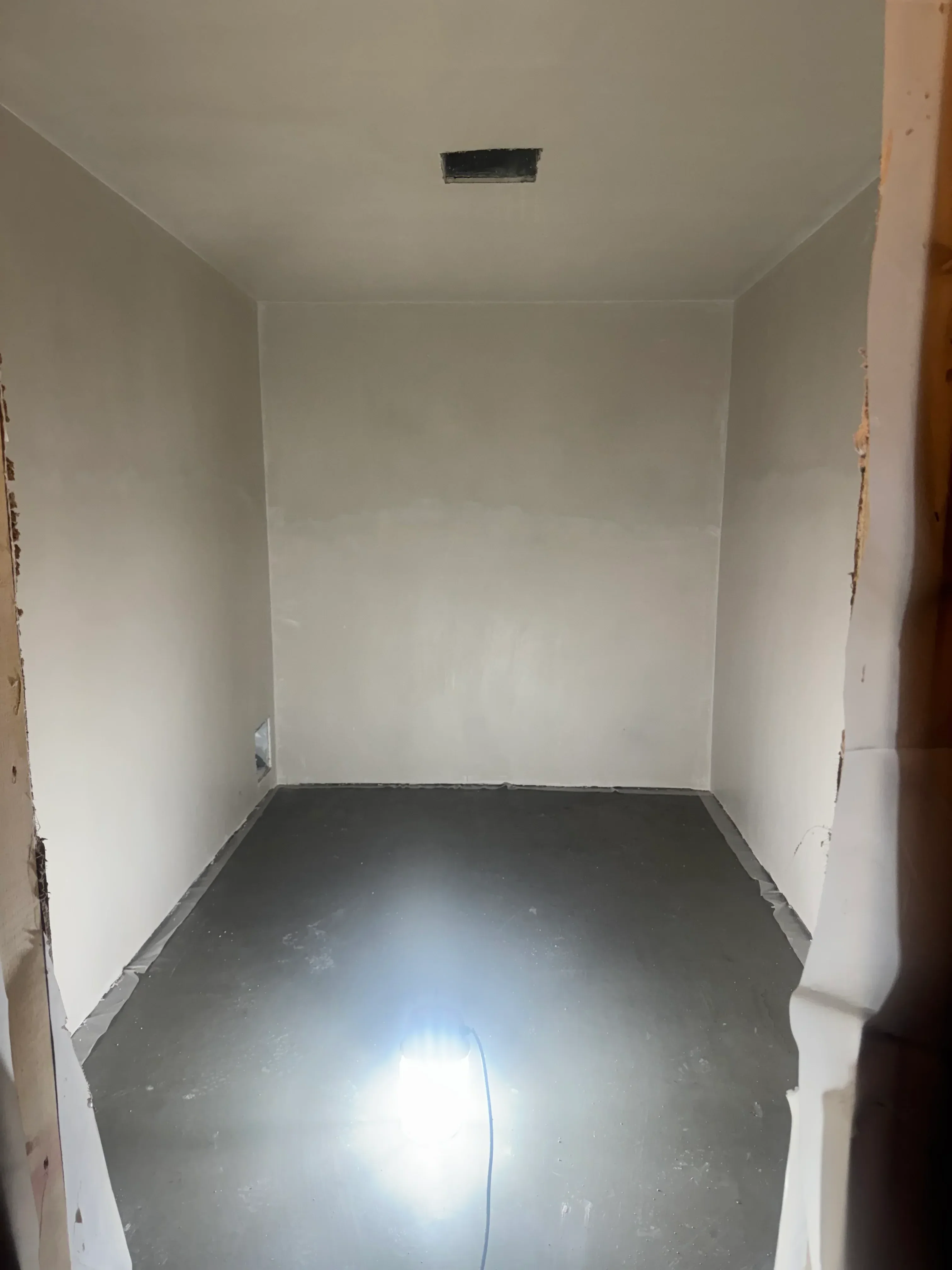 Finished drywall walls with taped seams and electrical outlet box installation