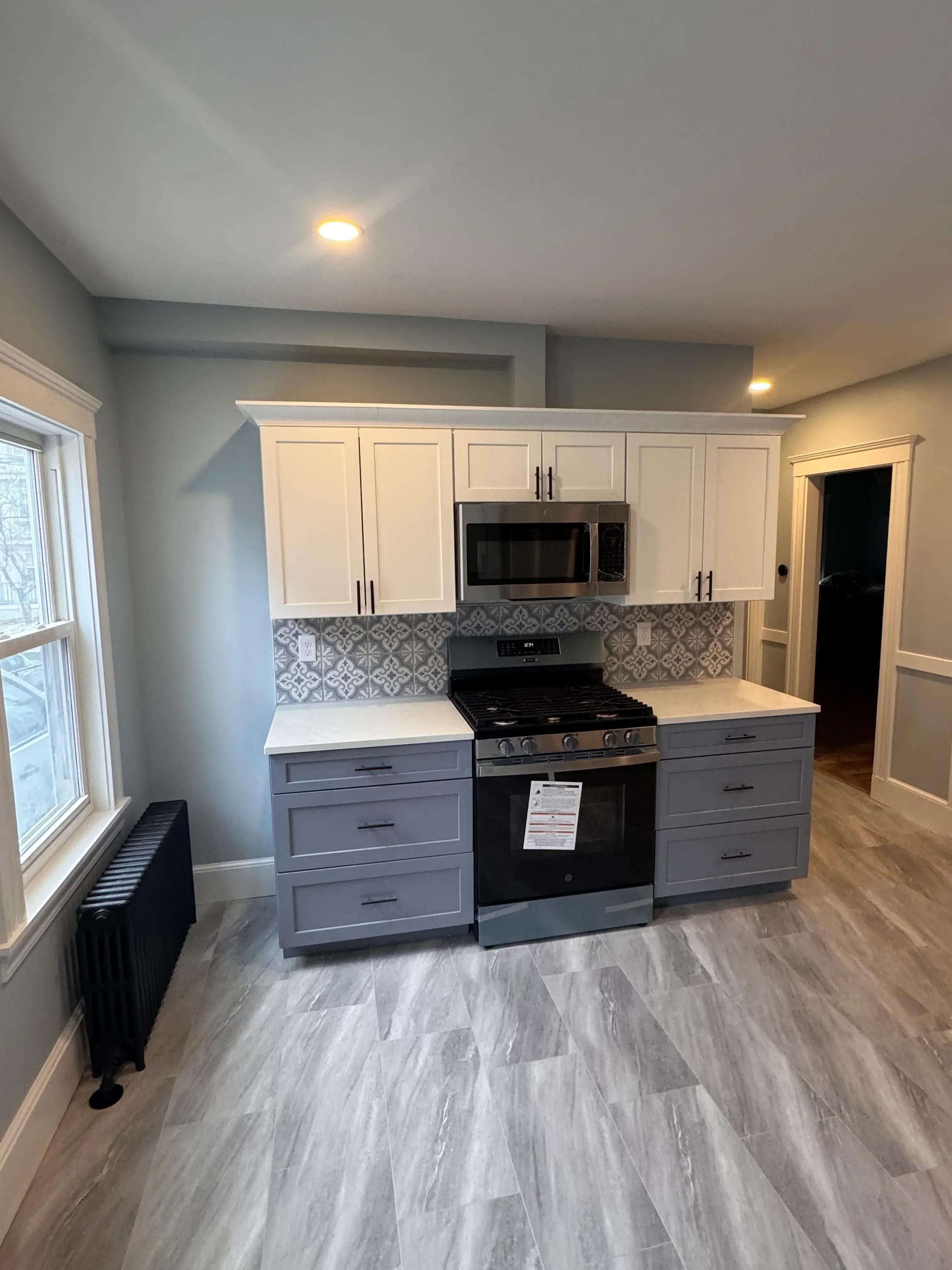Custom kitchen cabinets, tile backsplash, and luxury vinyl plank flooring installation