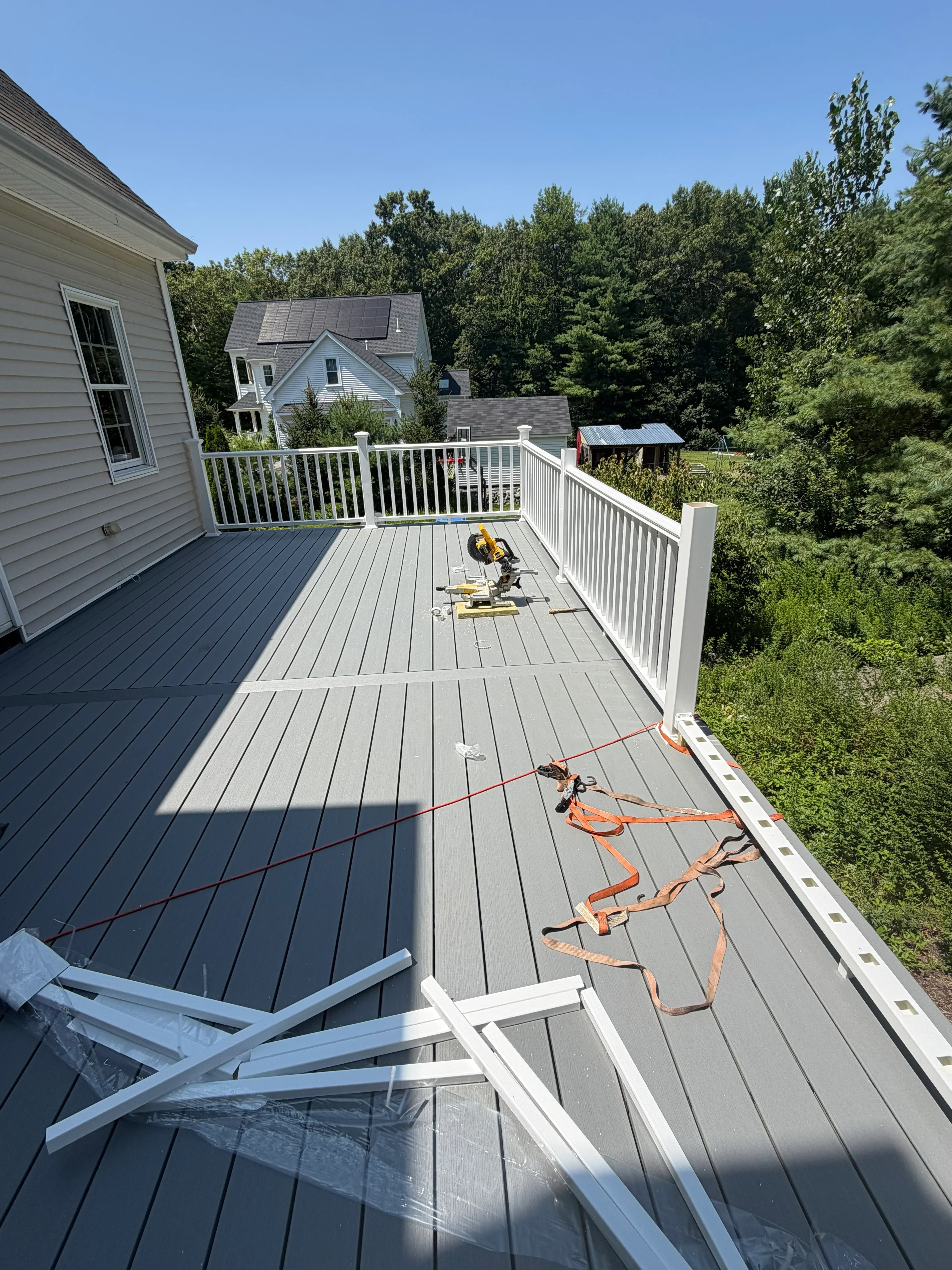 Charcoal gray horizontal siding with white trim and soffit on residential exterior