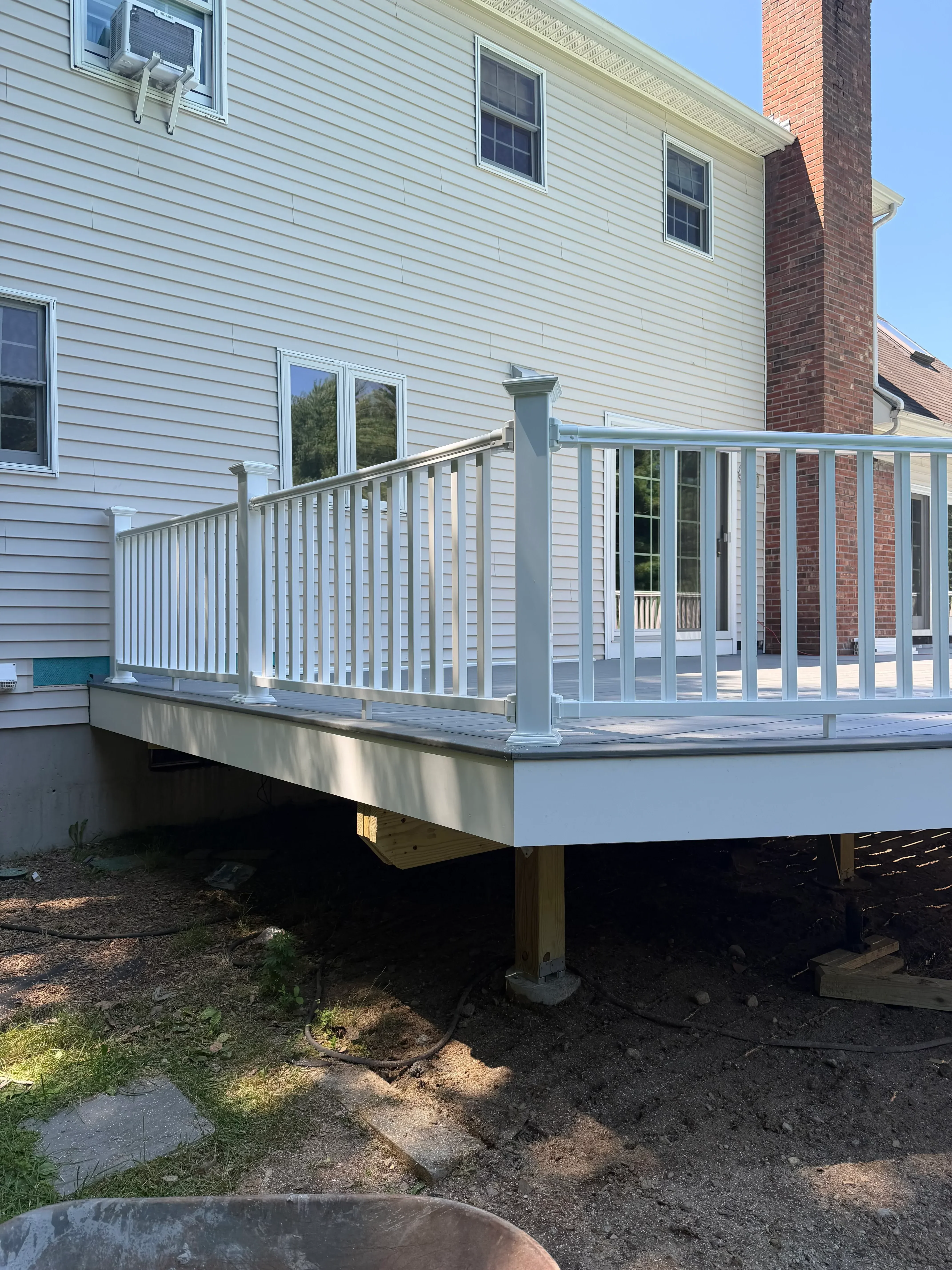 Metal exterior staircase with aluminum frame and horizontal railings attached to metal-sided building