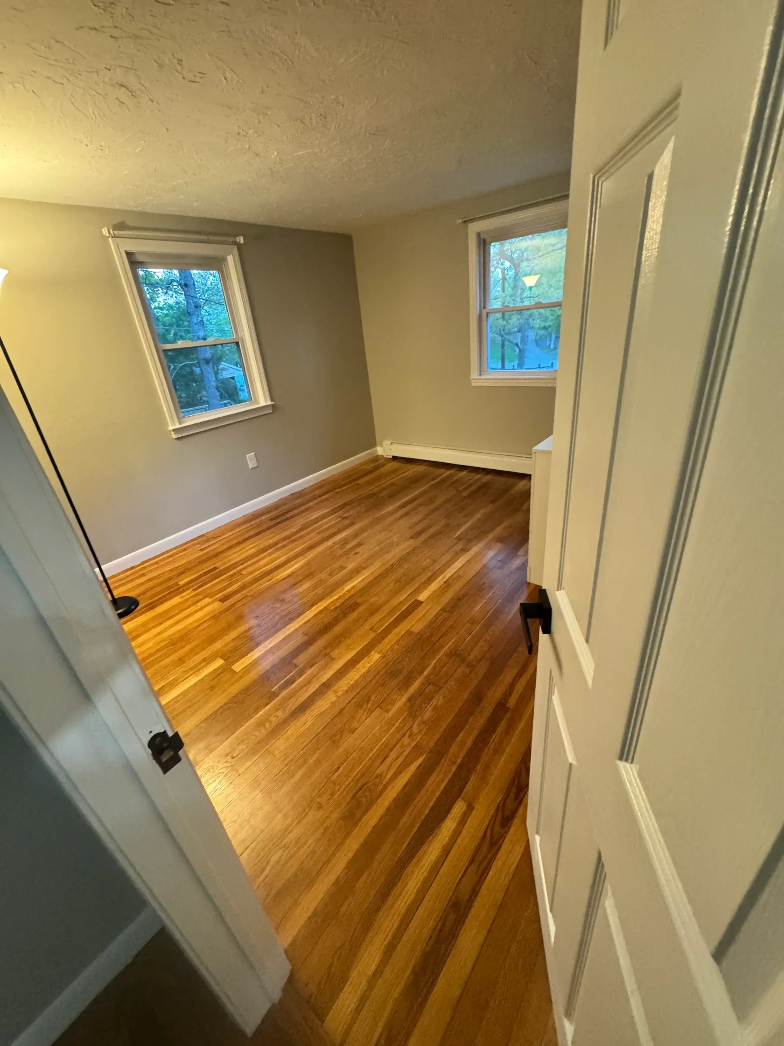 Diagonal hardwood flooring with cream drywall ceiling, trim work, and recessed lighting