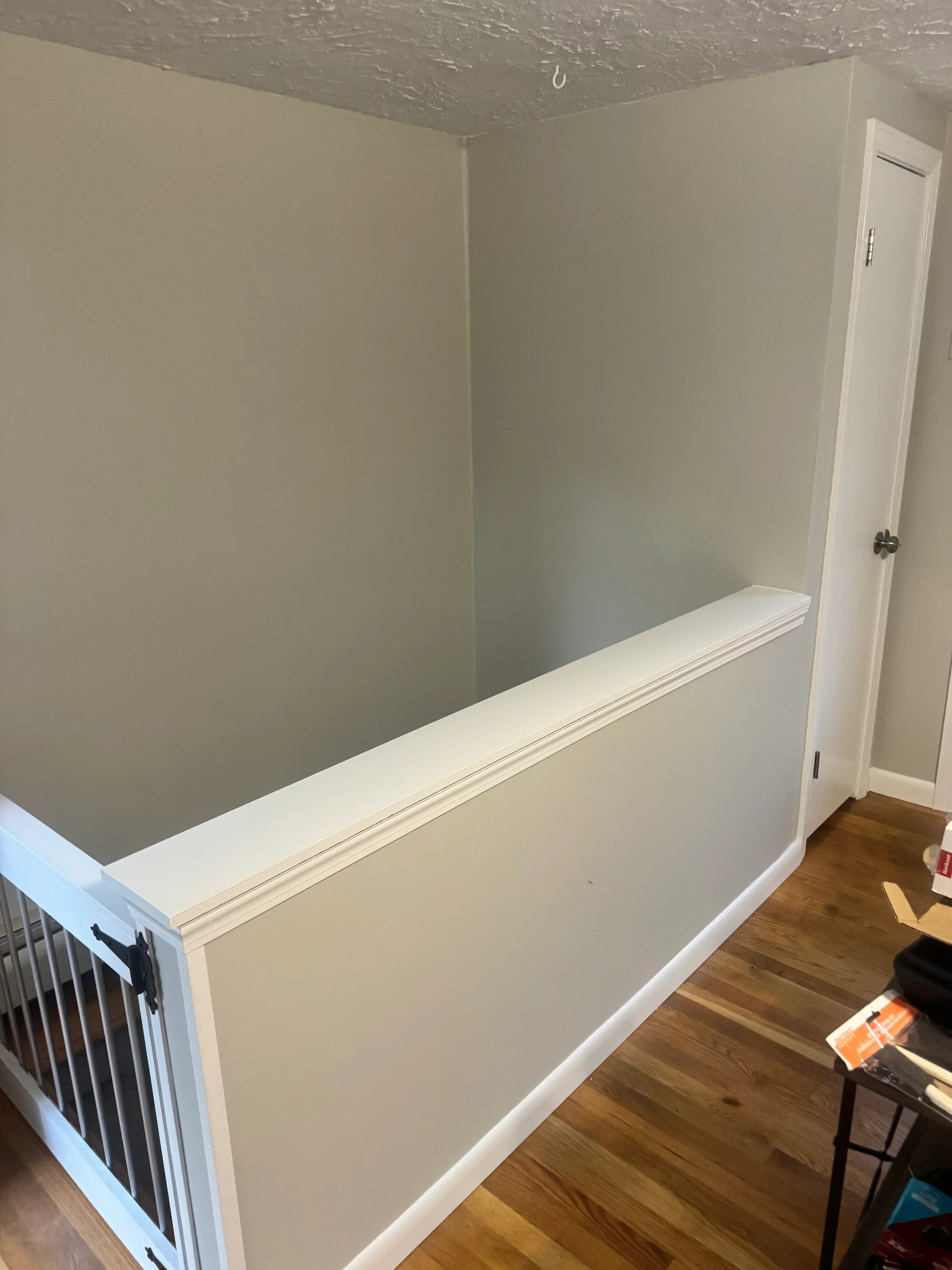 White painted built-in bench with lift-top lid and center divider trim detail