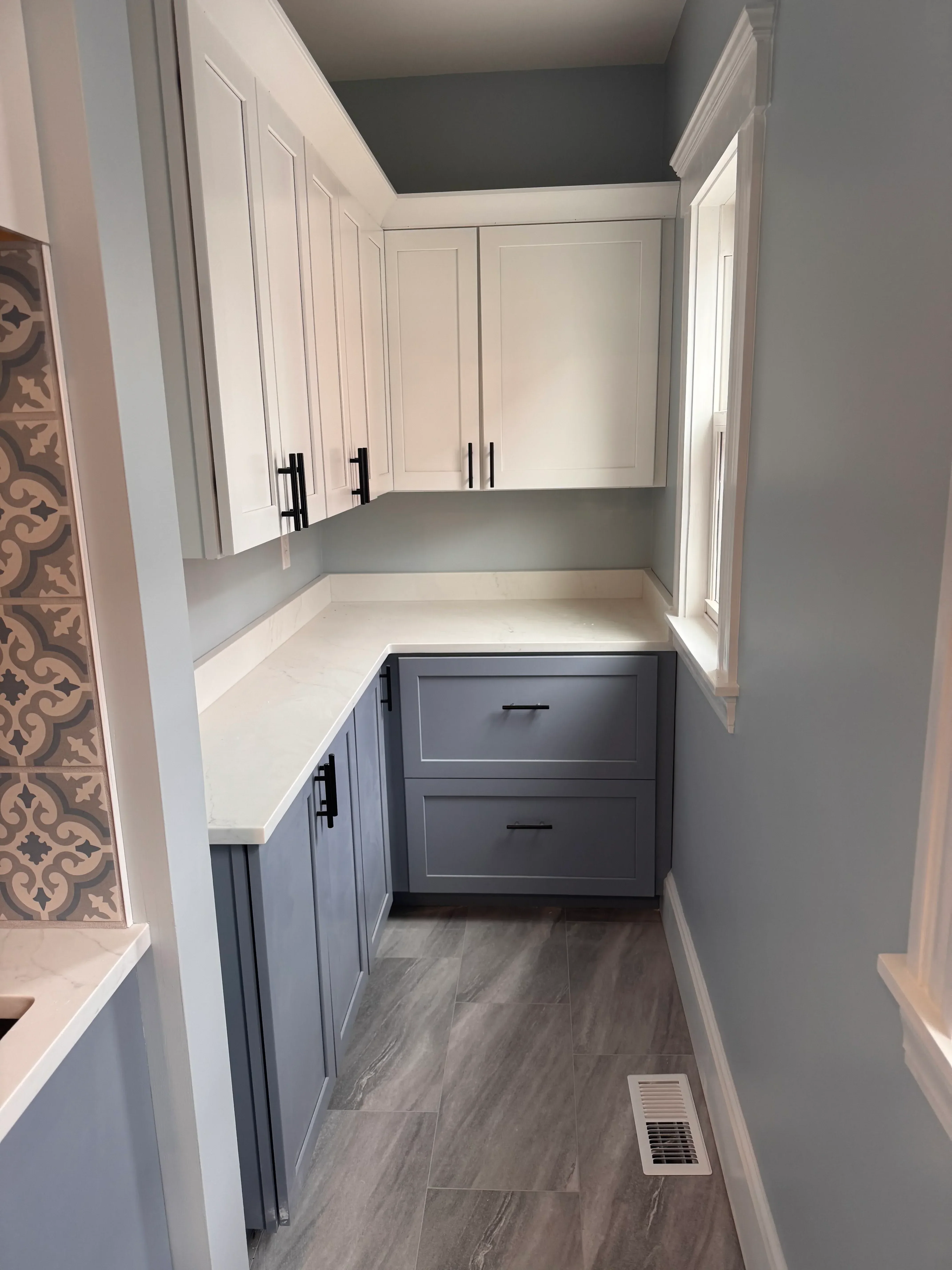 Two custom Murphy beds with white and gray cabinetry, LED lighting, and black hardware in bedroom